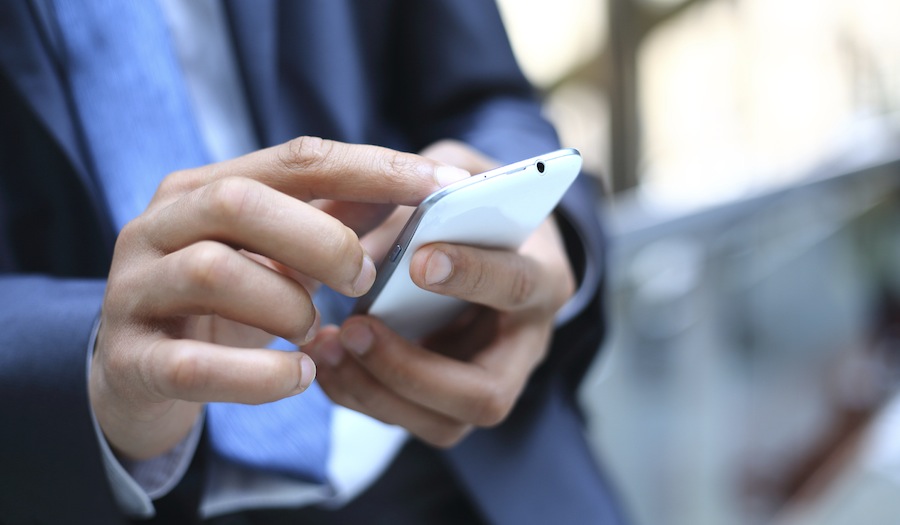 Close up of a man using mobile smart phone